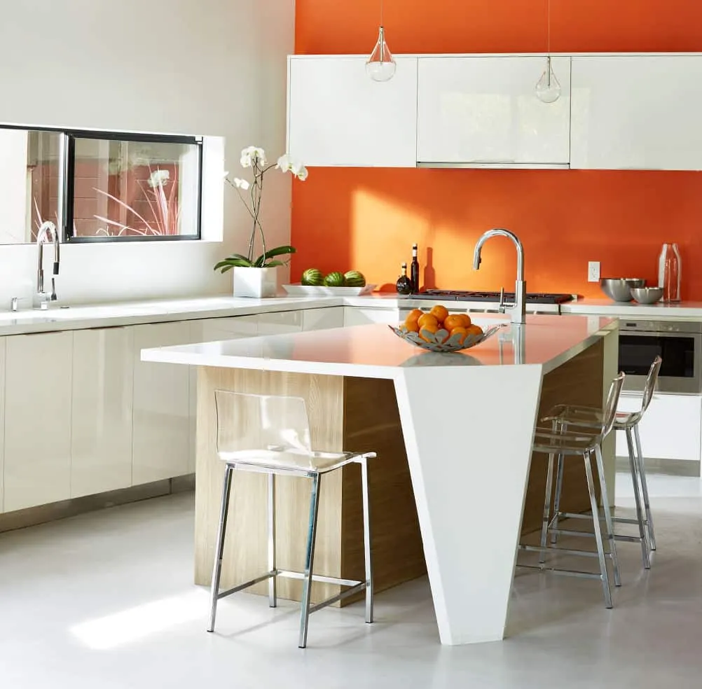 A kitchen with a table in a room