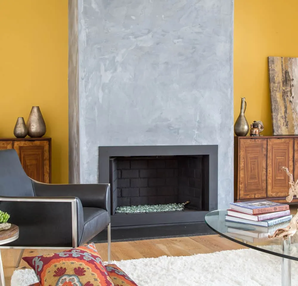 A living room filled with furniture and a fire place