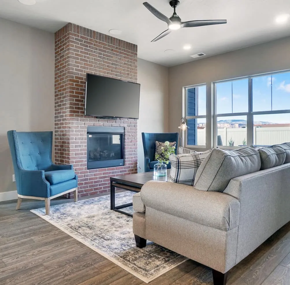 A living room filled with furniture and a large window