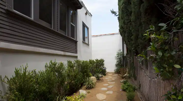 A house with bushes in the background