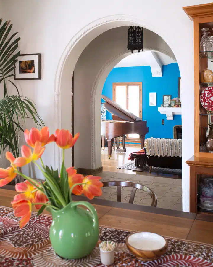 A room filled with furniture and vase of flowers on a table