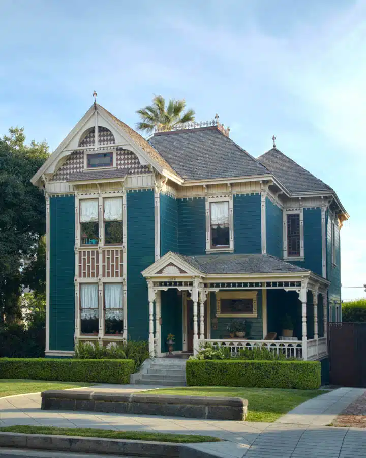 A large brick building with grass in front of a house