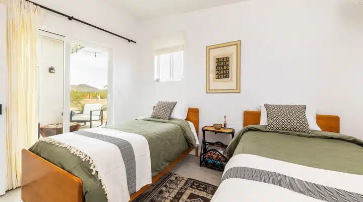 A bedroom with a bed and desk in a hotel room