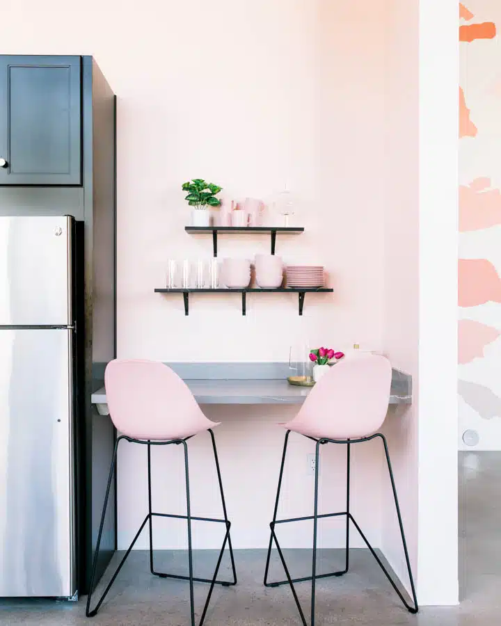 A kitchen with a table in a room