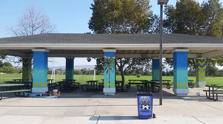 A group of people sitting in a parking lot