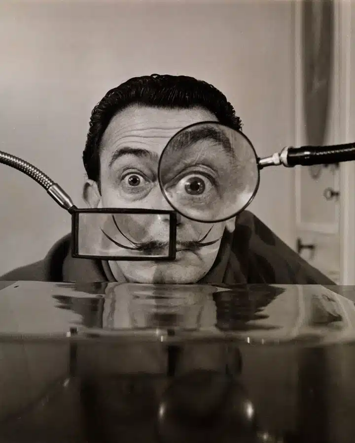 A man standing in front of a mirror posing for the camera