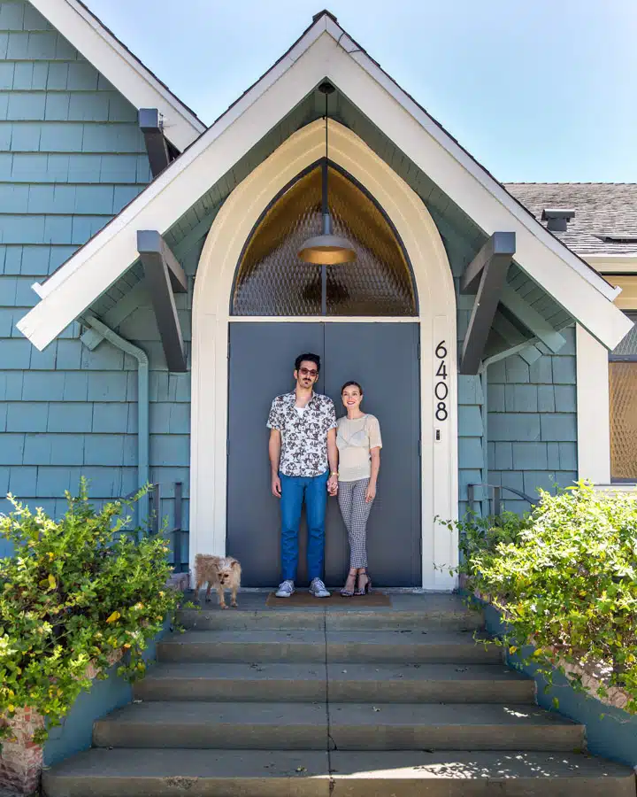 A person standing in front of a house