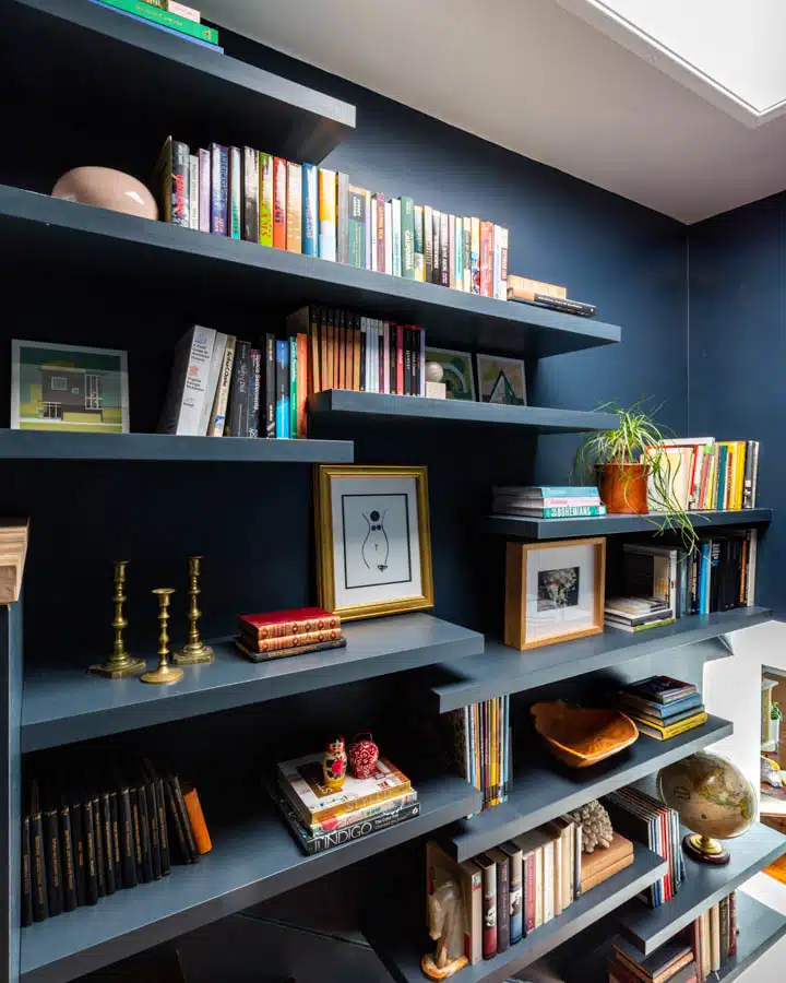 A desktop computer sitting on top of a book shelf