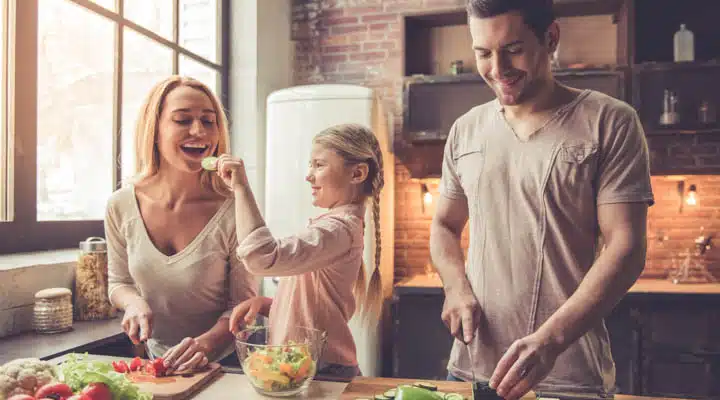 A man and a woman sitting at a table with food