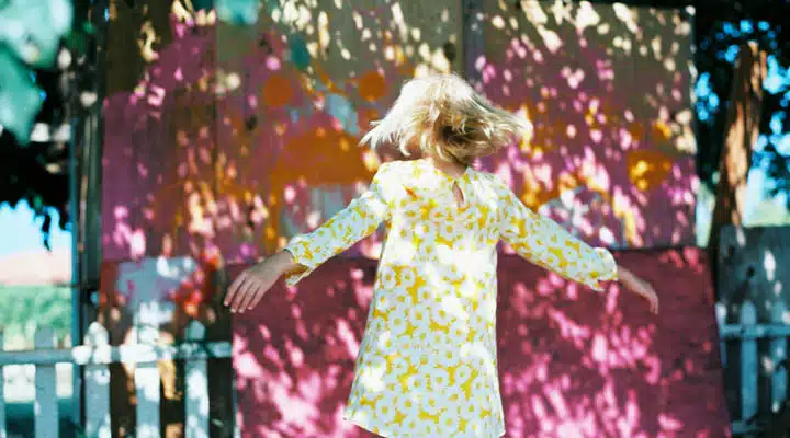 A person standing in front of a colorful dress