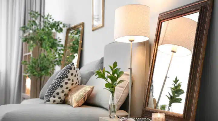 A living room filled with furniture and vase of flowers on a table