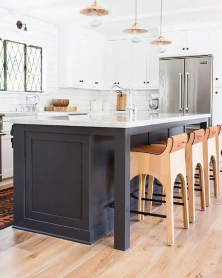 A kitchen with wooden cabinets and a wood floor