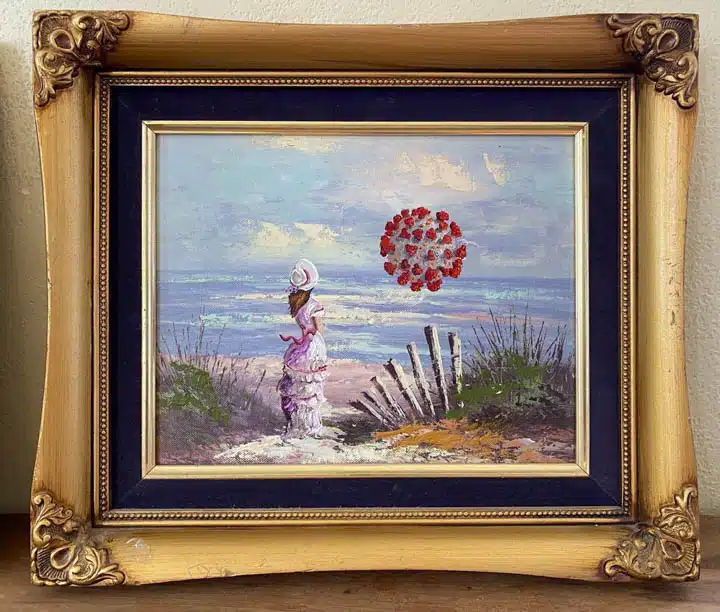 A painting in a frame hanging on a wall