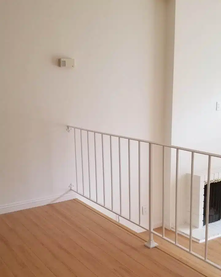 A bedroom with a wooden floor