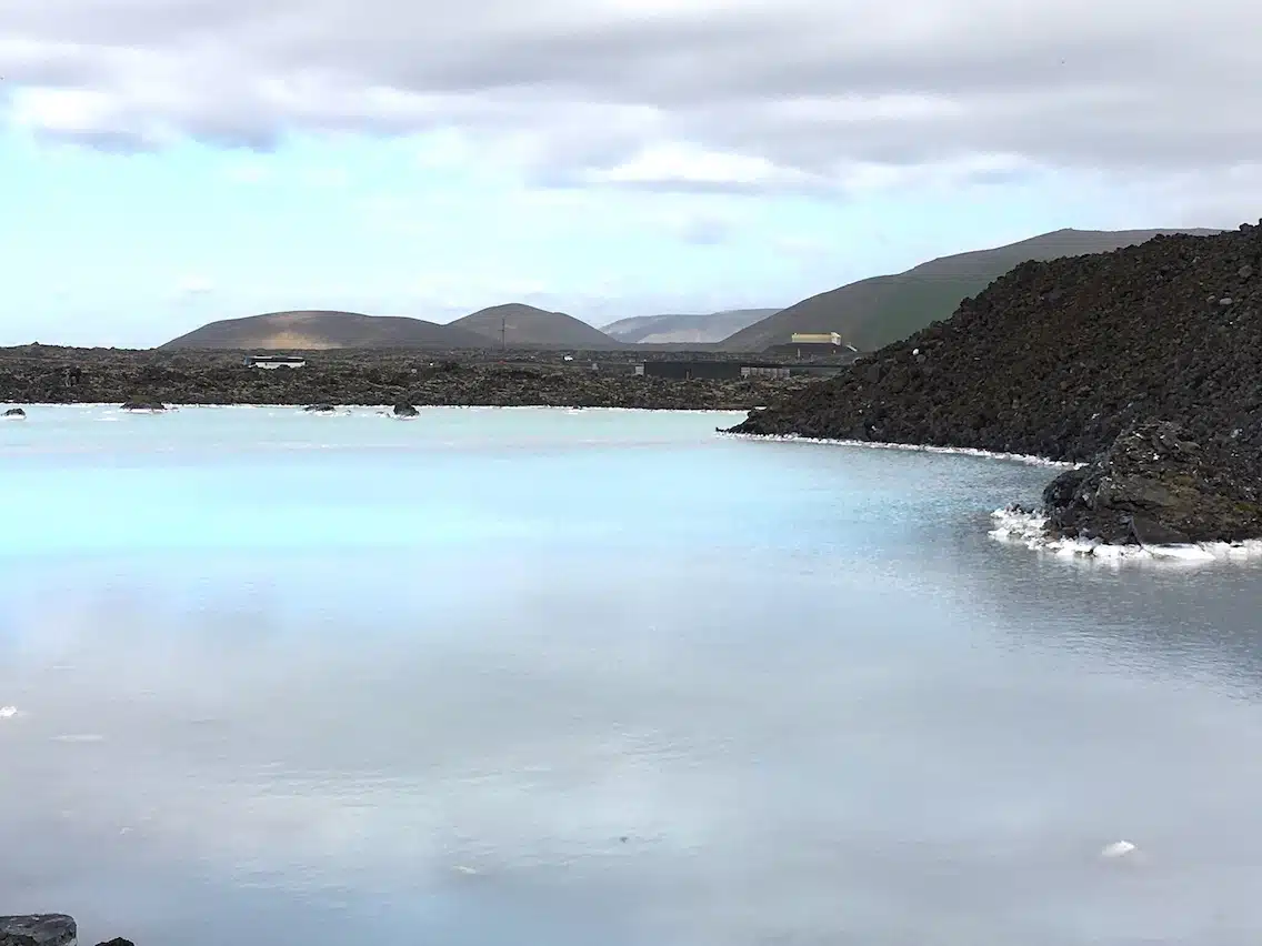 A body of water with a mountain in the background