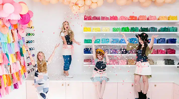 A person taking a selfie in a room with many items on the counter