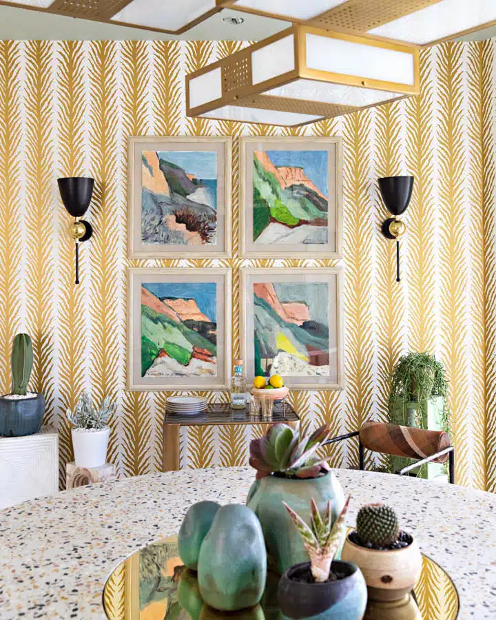 A bedroom with a vase of flowers on a table