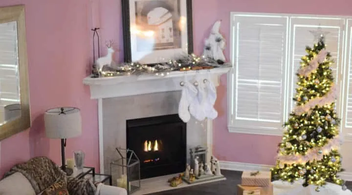 A living room filled with furniture and vase of flowers next to a fireplace