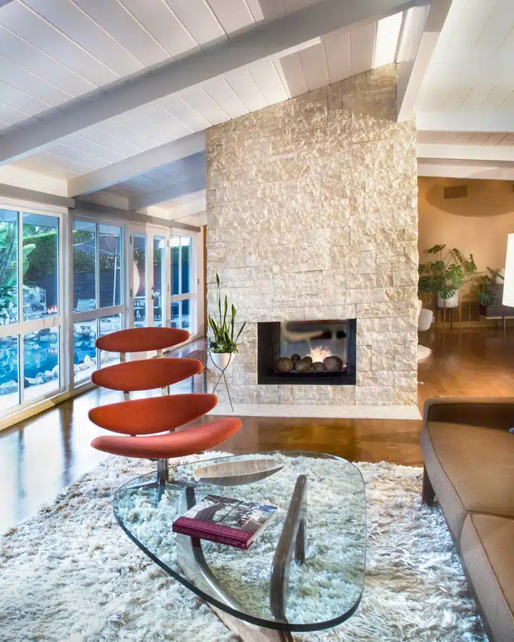 A living room filled with furniture and a fire place sitting in a chair