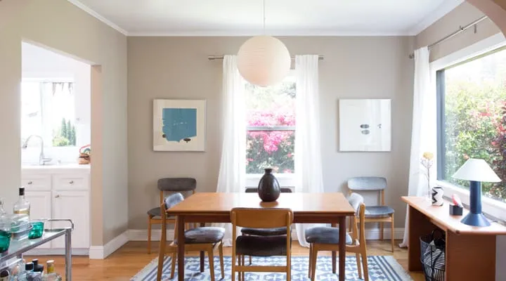 A dining room table in front of a window