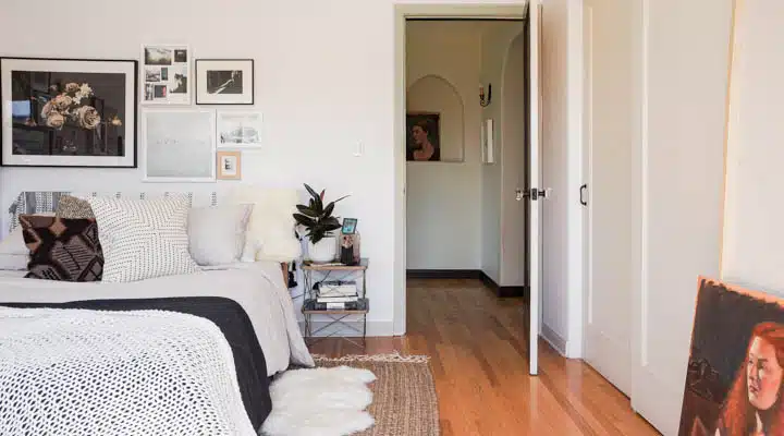 A bedroom with a bed and a couch in a living room