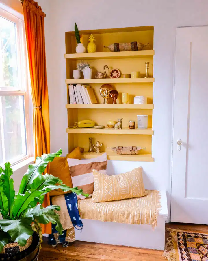 A living room filled with furniture and vase of flowers on a table