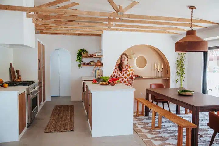 A kitchen with wooden cabinets and a dining room table