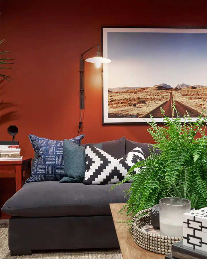 A living room filled with furniture and vase of flowers on a table