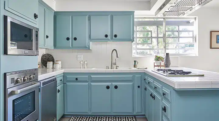 A kitchen with a stove top oven sitting next to a window