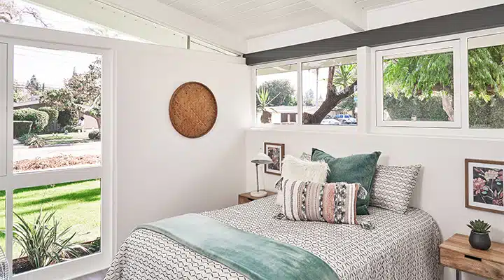 A living room with a bed and a window