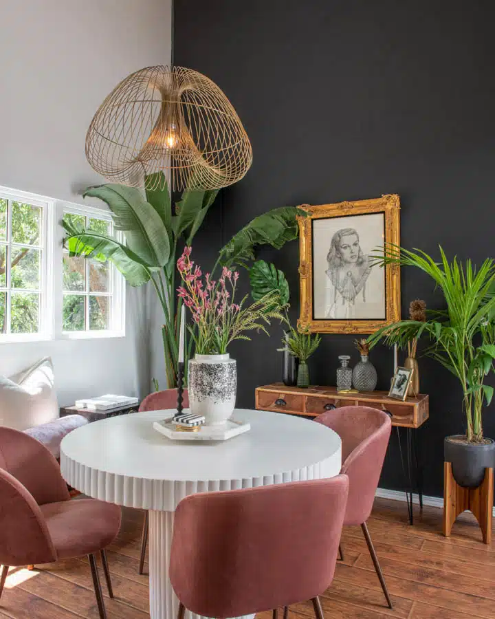 A living room filled with furniture and vase of flowers on a table