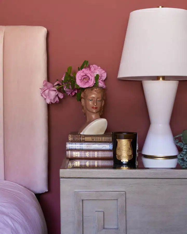 A living room filled with furniture and vase of flowers on a table