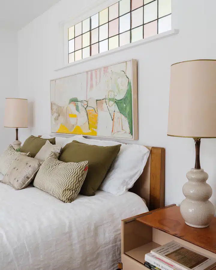 A bedroom with a bed and desk in a room