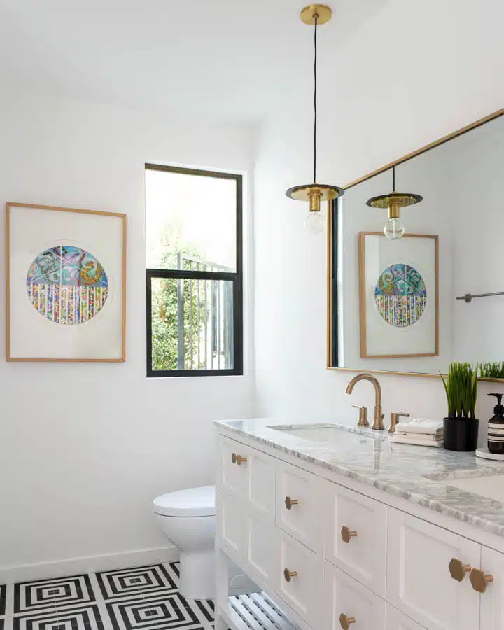 A kitchen with a sink and a mirror