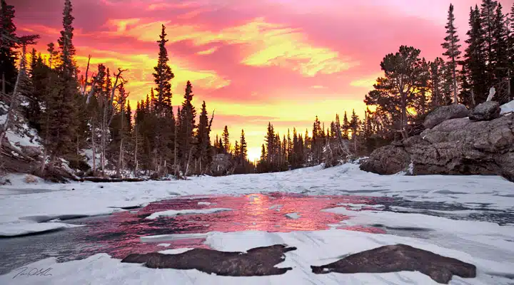 A man with a sunset in the snow