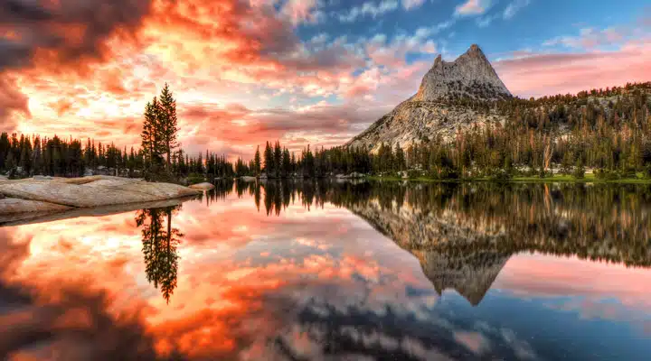 A pond with a mountain in the background