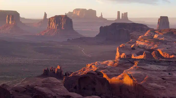 A canyon with a sunset in the background