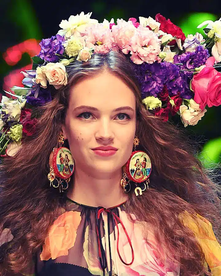 A woman holding a bunch of pink flowers