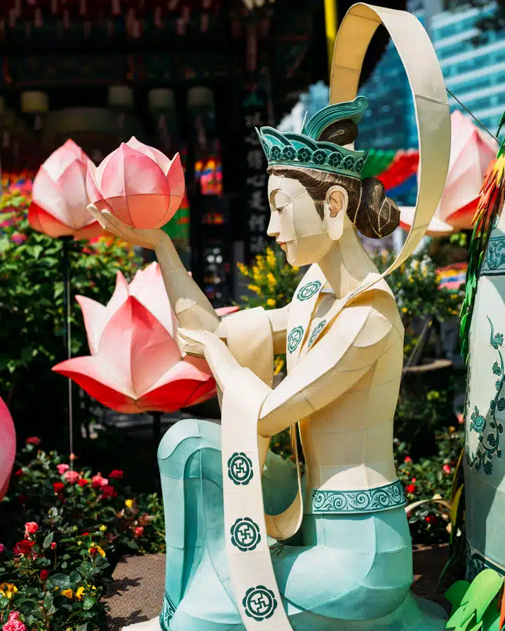 A person standing in front of a flower