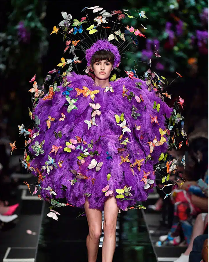 A woman holding a purple flower