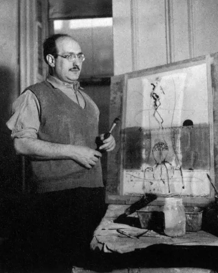 A man standing in front of a mirror posing for the camera