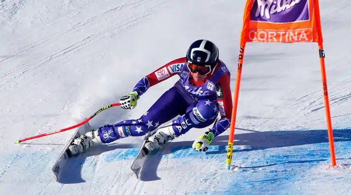 A man riding skis down a snow covered slope