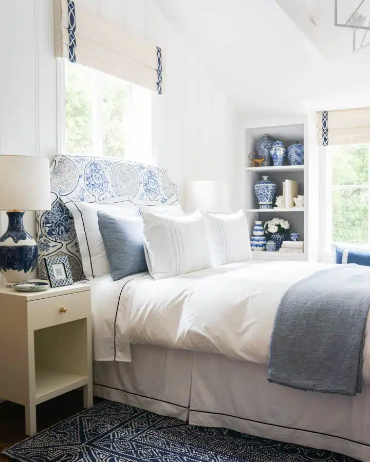 A bedroom with a bed and a chair in a room