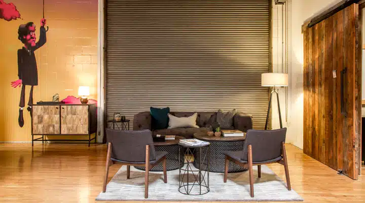 A living room filled with furniture on top of a wooden floor