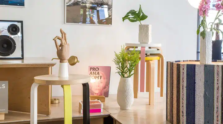 A room filled with furniture and vase of flowers on a table