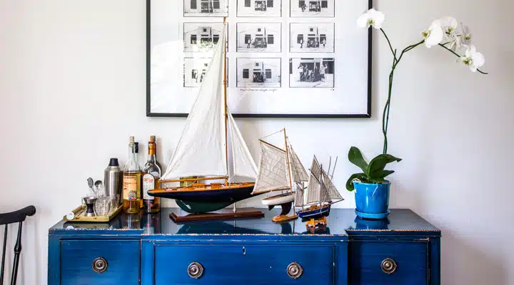 A kitchen with a blue vase on a table