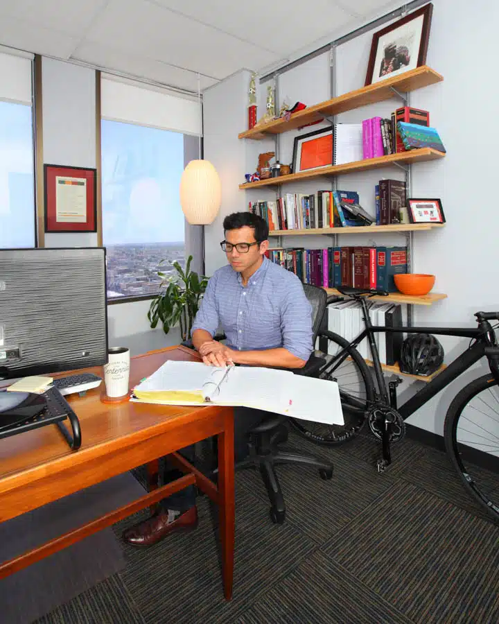 A desk with a laptop computer sitting on top of a chair