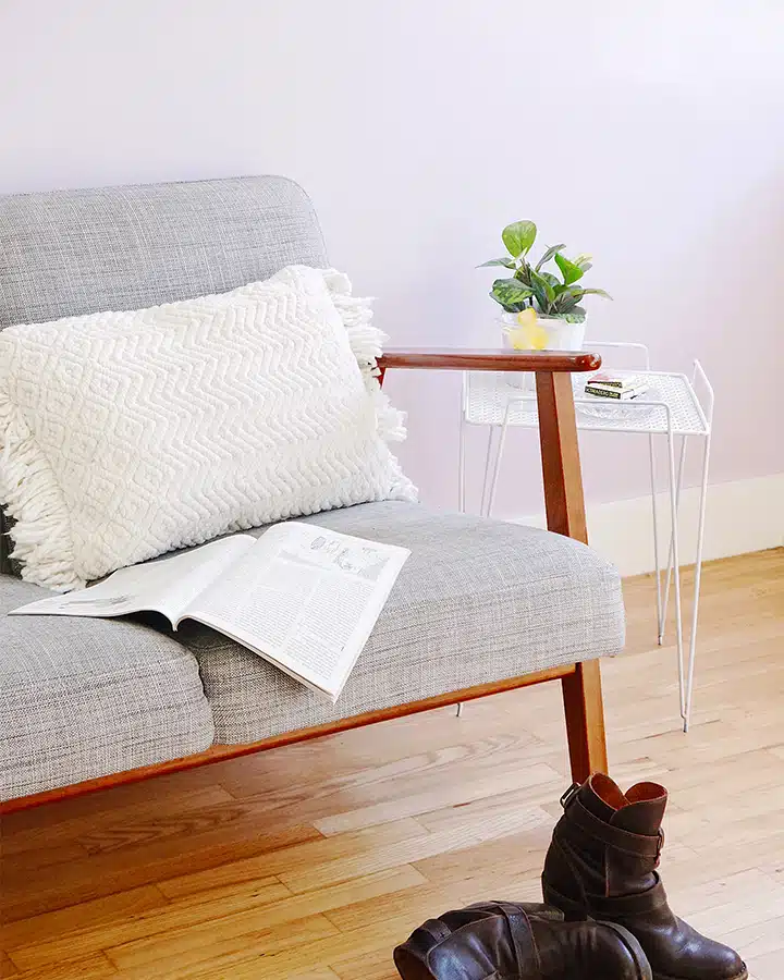 A bedroom with a bed and a chair in a room