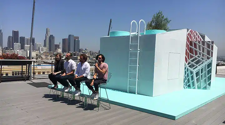 A group of people standing around a bench