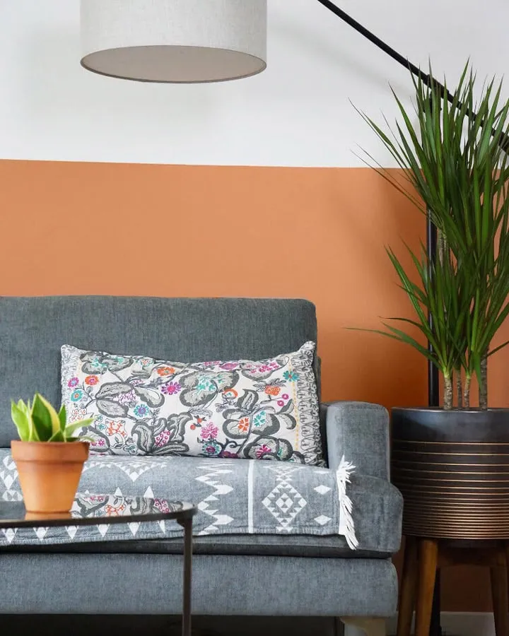 A living room filled with furniture and vase of flowers on a table